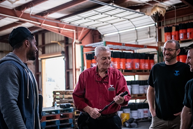 Tanner Tees founder Joe Tanner holds Flextop with Ian Desmond and Tanner Tees staff